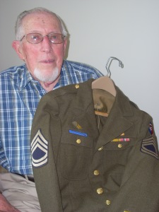 WWII vet Richard Beitler holds the uniform he wore 70 years ago.